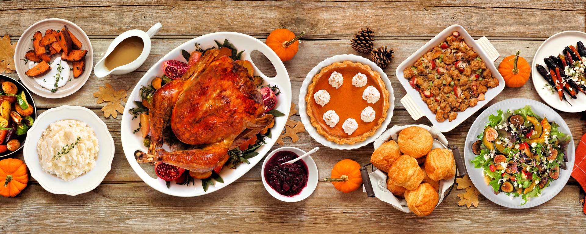 Thanksgiving turkey dinner. Above view table scene on a rustic wood banner background.